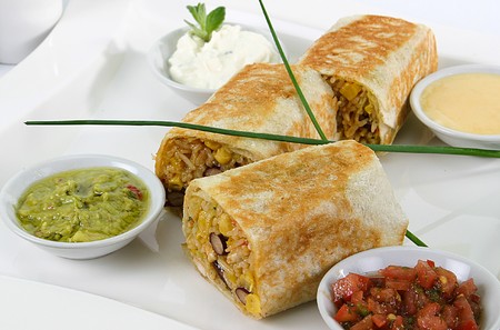 Mexican Rolled Sandwich of Rice mix on a white plate and sauce setの写真素材