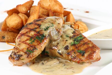 Grilled Chicken Steak in mushroom's sauce & Fried Potato Wedges, on a white backgroundの写真素材