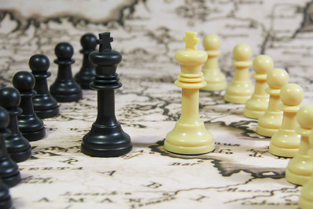 Chess Stones on a Map, whites agains blacks, and the kings facing each other in the middleの写真素材