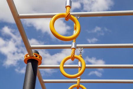 Yellow sports rings on a sports field under a bright blue sky. soft focusの写真素材