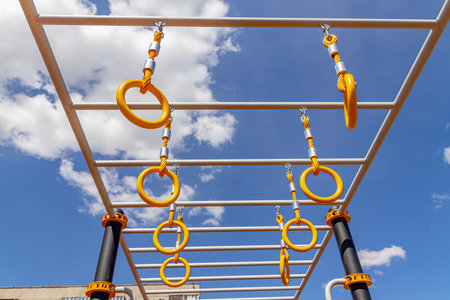 Yellow sports rings on a sports field under a bright blue sky. soft focusの写真素材