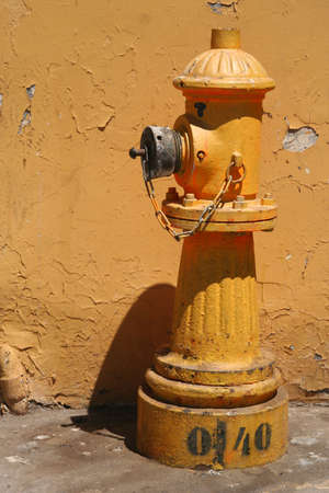 Yellow hydrant in front of the yellow building