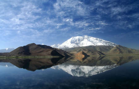 Mountain reflection in the Kara Kul lake in Karakorum Chinaの写真素材