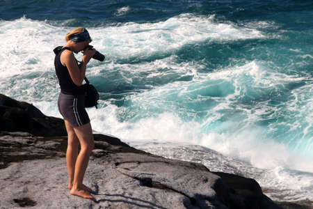Girl taking photo of the beautiful seashore on the Nosy Antafa island in Madagascarの写真素材
