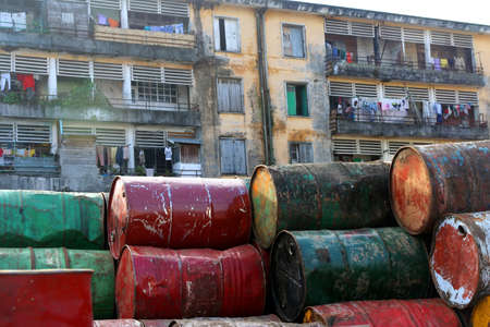 Barrels with waste left in front of a block of flats, Tamatave, Madagascar