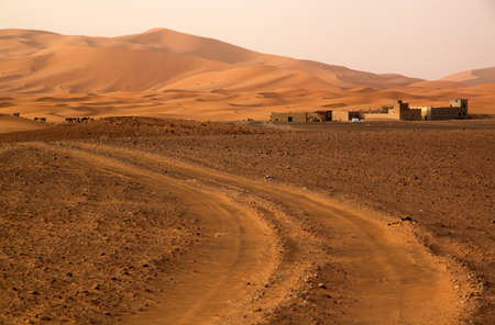 Road leading to the impressive sand dunes of Sahara desert in Merzouga, Morocco