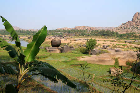 Small picturesque ricefields among stunning rocky scenery in Hampi, Indiaの写真素材