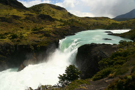 Beautiful and powerful Salto Grande waterfall in Torres del Paine National Park in Chileの写真素材