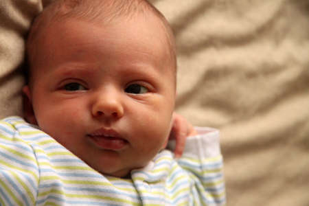 Newborn baby girl lying on the bed