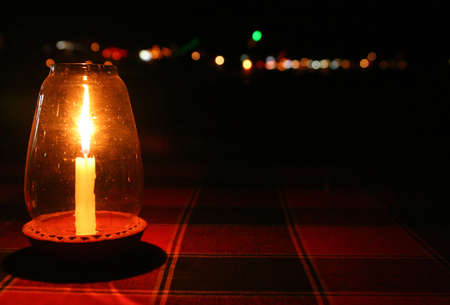 Candle lamp on the table prepared for a romantic dinnerの写真素材