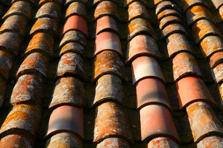 Old weathered roof tiles covering roof of indoesian house, Java, Indonesiaの写真素材