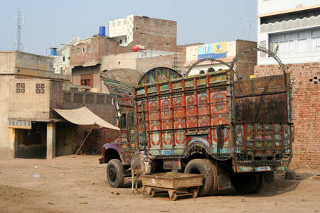 Colourful pakistani truck standing at the back of a store in Pakistanのeditorial素材