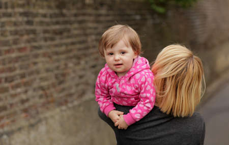 Mother carrying her daughter home after day spent outdoorsの写真素材