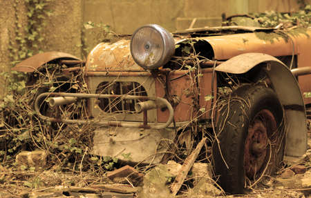 Old forgotten car rusting at the backyard of an old english propertyの写真素材