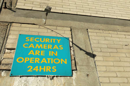 Board informing that security cameras are in operation 24hrsの写真素材