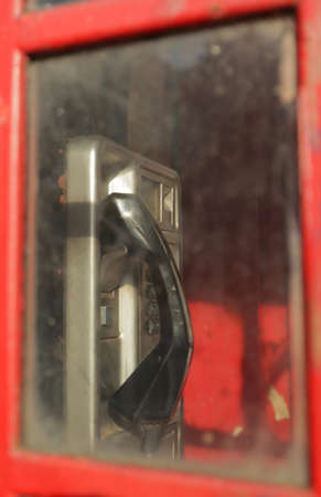 Public phone inside the traditional red London telephone booth, Englandの写真素材