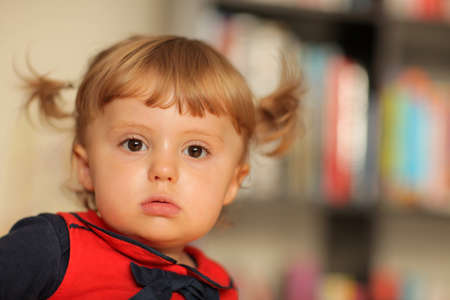 Portrait of a cute little baby girl with the ponytailsの写真素材