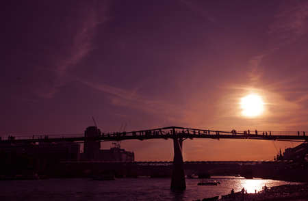 London Millennium Footbridge across Thames river at sunsetの写真素材