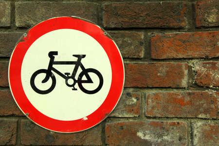 Cycling forbidden sign placed on the brick wallの写真素材
