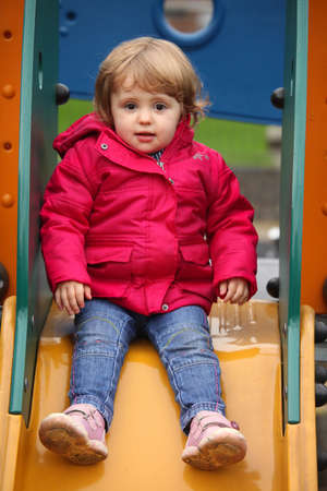Little girl having fun on a slide in an indoor activity centre