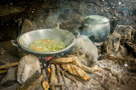 Pot and kettle with simple meal cooked by a porter on a trek in Lombok, Indonesiaの写真素材