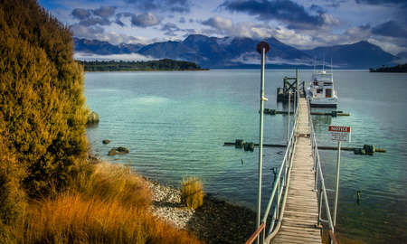 Wooden pier on Te Anau lake in New Zealand South Islandの写真素材