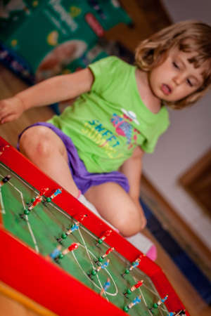 Close-up shot of red and blue players of a tabletop football gameの写真素材