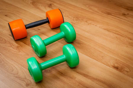 Three light exercise weights on the floorの写真素材