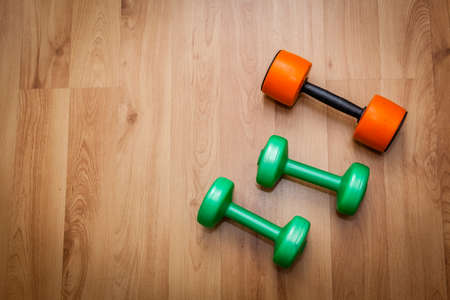 Three light exercise weights on the floorの写真素材