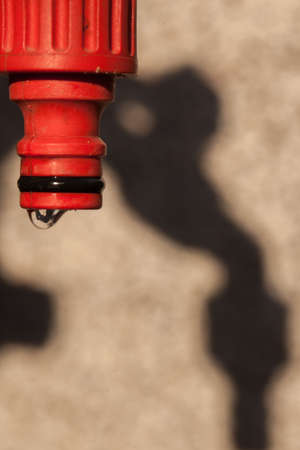 Water dripping from  a hose in the gardenの写真素材