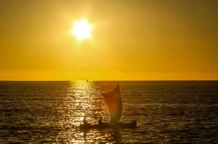 Traditional fishing pirogue sailing on the oceanの写真素材