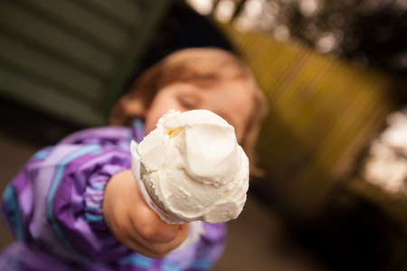 Cute little girl showing her ice creamの写真素材