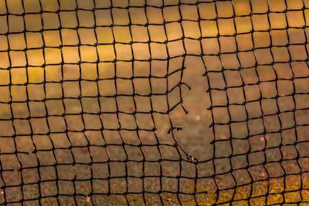 Close up view of the hole in the tennis netの写真素材
