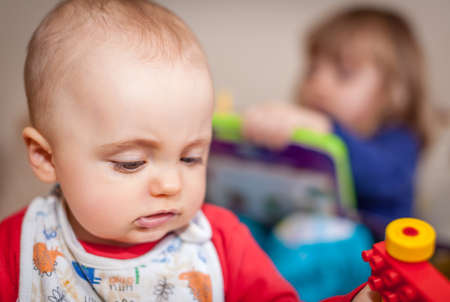 Brother and sister - siblings, kids, playing with toys in their room at homeの写真素材