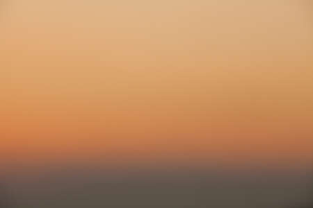 Defocused autumn sunset red orange and yellow colors backgroundの写真素材