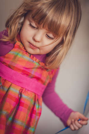 Portrait of a little baby girl dressed for a party and holding baloon