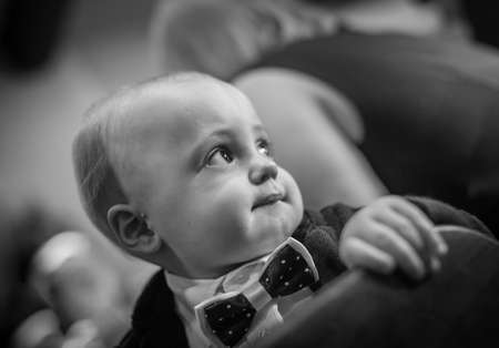 Portrait of a smartly dressed cute little baby boy during weddingの写真素材