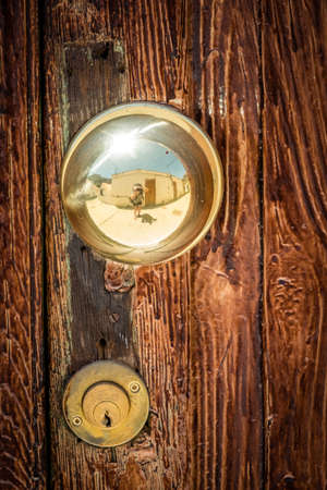 Golden door knob on wooden doors in Fataga in gran Canariaの写真素材