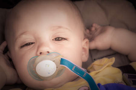 Portrait of a happy and adorable baby boy 12 months old in his pushchair