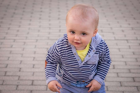 Happy ittle boy on a walk in the town