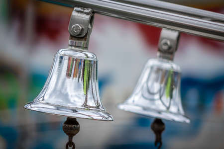 Two silver bells on a train on a funfairの写真素材