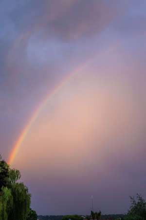 Large rainbow over the London suburb, summerの写真素材