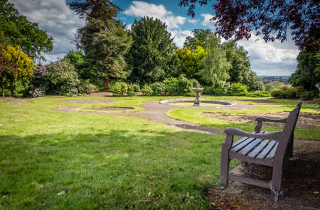 Empty bench In a park in spring, Englandの写真素材