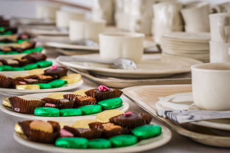 Anniversary event reception table with mints and sweets and coffee cups