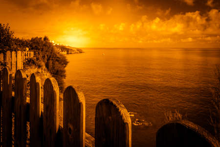 Wooden fence and the view of the sea, Cornwall, Englandの写真素材