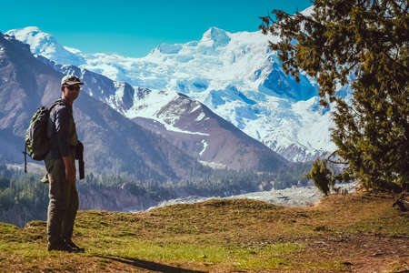 Trekker walking up the stony mountain trail in Karakorum in Pakistan