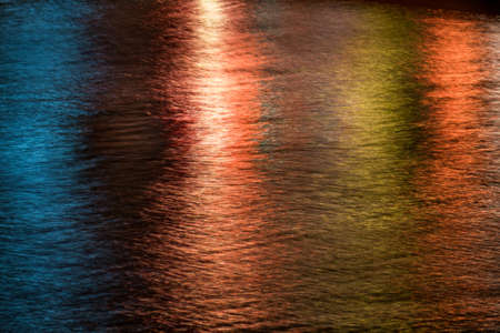 Abstract multicolour lights pattern created on a river surfaceの写真素材