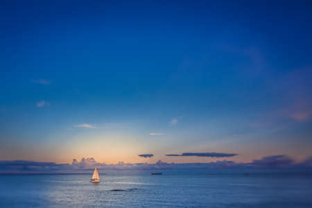 Small sailboat on a calm sea in Penzance, Cornwall, England, UKの写真素材
