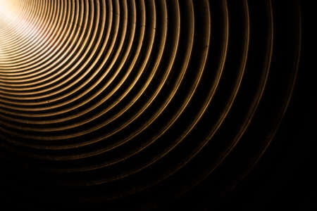 Light getting into the large metal tunnel pipe on a kids playgroundの写真素材