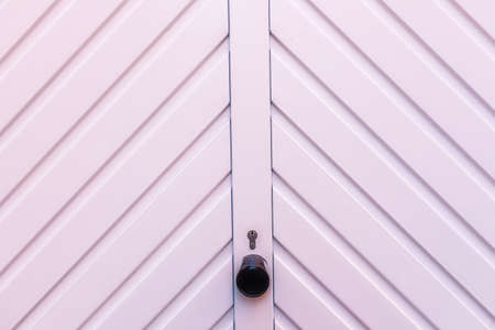 White garage door detail with a lock and keyholeの写真素材
